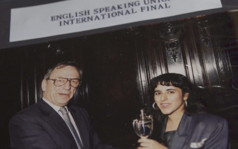 An image of the young Anita Anand receiving a trophy in an international competition final