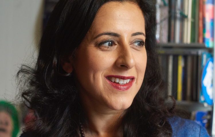 Anita Anand close-up with bookshelf behind