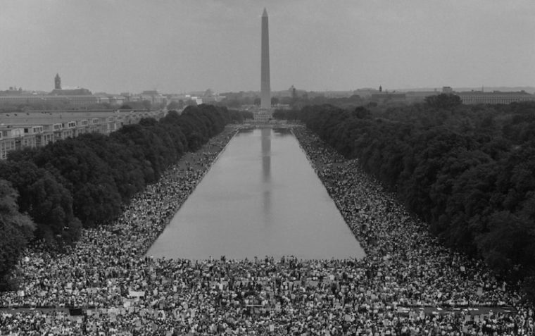 Image of statue in Washington with crowds of people marching for civil rights