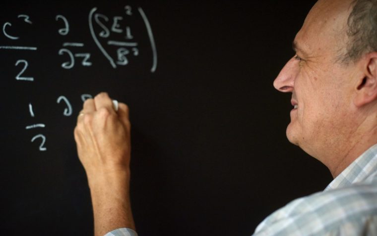 Martin Laming, Astrophysicist scribbles algebra onto black board.