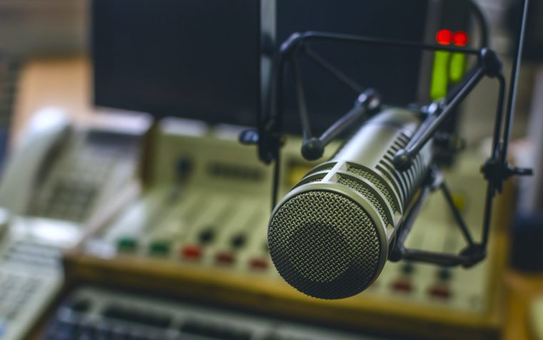 An image of a microphone and recording mixer.