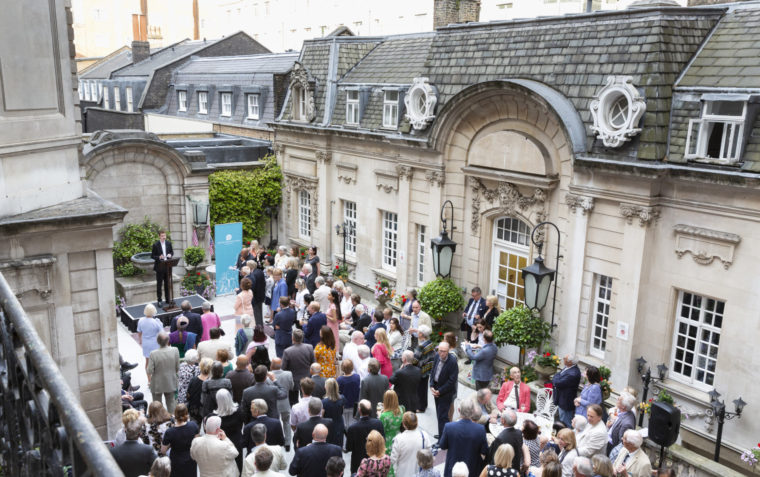 View from above of large group of people at an event in the courtyard of Dartmouth House