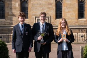 Oundle School students posing with their trophy