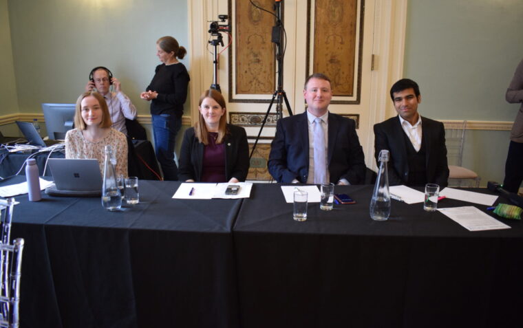 Photo of competition judges, including Hamza as a volunteer judge