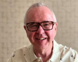 image of a man with grey hair wearing glasses