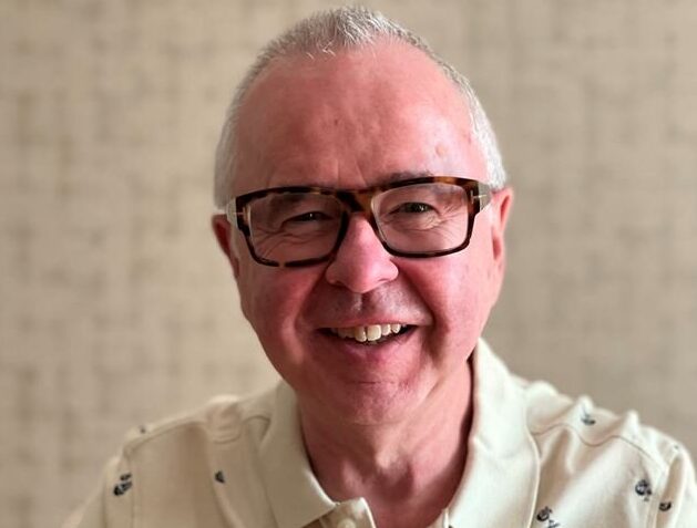 image of a man with grey hair wearing glasses