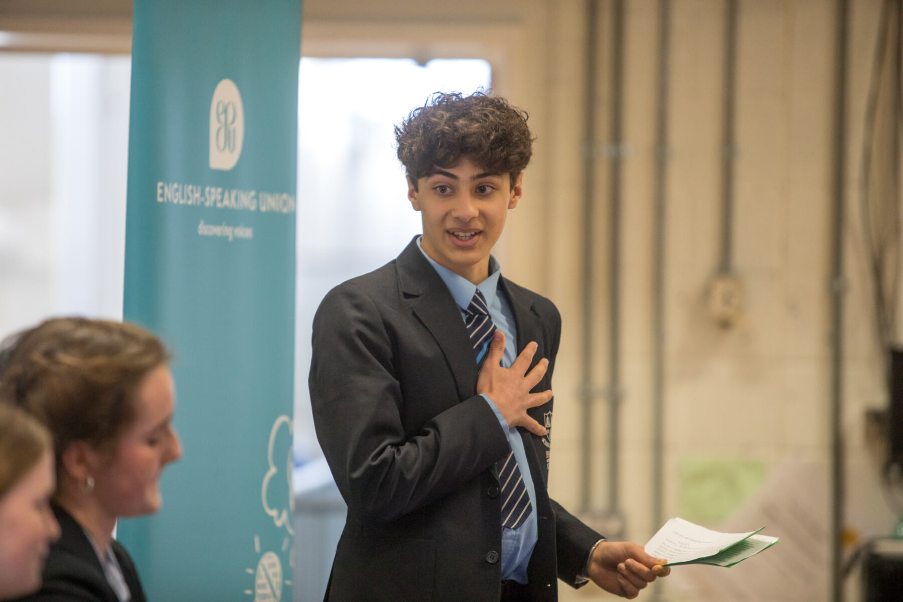School boy talking passionately with hand on chest at ESU competition
